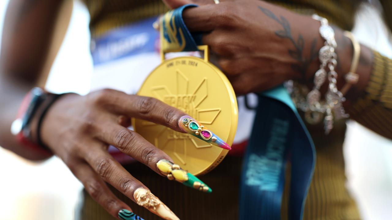 Sha'Carri Richardson's nails with her gold medal. Picture: Getty Images