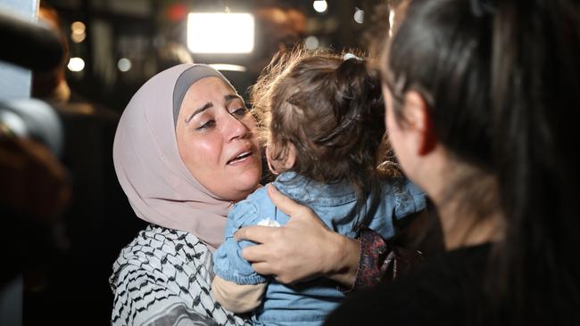 Mona pictured with family and friends as she arrives at Sydney Airport after travelling from Gaza. Picture: Damian Shaw