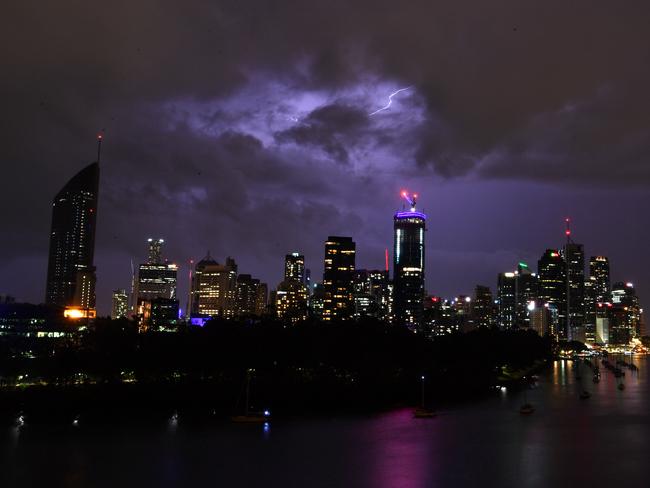 Storm clouds and lightning are seen passing over the Brisbane skyline from the Kangaroo Point cliffs in Brisbane, Tuesday, December 26, 2017.(AAP Image/Darren England) NO ARCHIVING