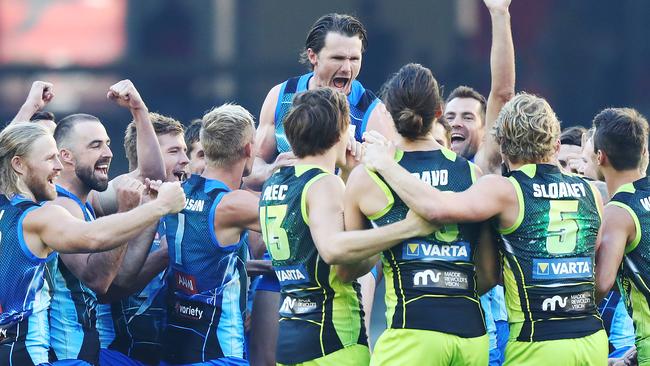 Patrick Dangerfield and his teammates are animated after winning rock-paper-scissors to decide the choice of ends. Picture: Getty Images