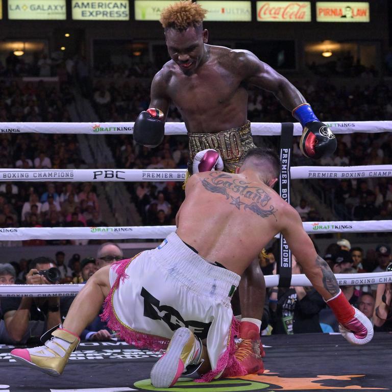 Jermell Charlo (gold/red shorts) knocks down Brian Castano (white/pink shorts) during their super middleweight title fight at Dignity Health Sports Park on May 14, 2022. Picture: Jayne Kamin-Oncea/Getty Images