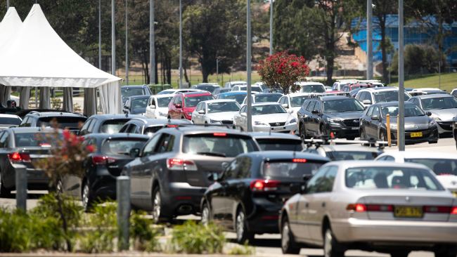 A mammoth queue of cars are seen at the Heffron Park drive-through COVID-19 test centre in Maroubra on Monday. Picture: Julian Andrews.