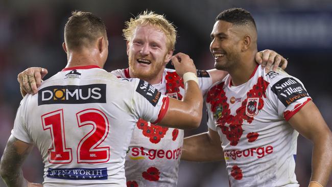 Tariq Sims, James Graham and Nene MacDonald celebrate the Dragons’ win.