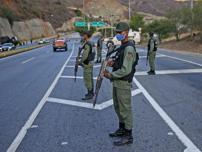 Members of the Bolivarian National Guard wearing protective face masks in Caracas. Picture: AFP