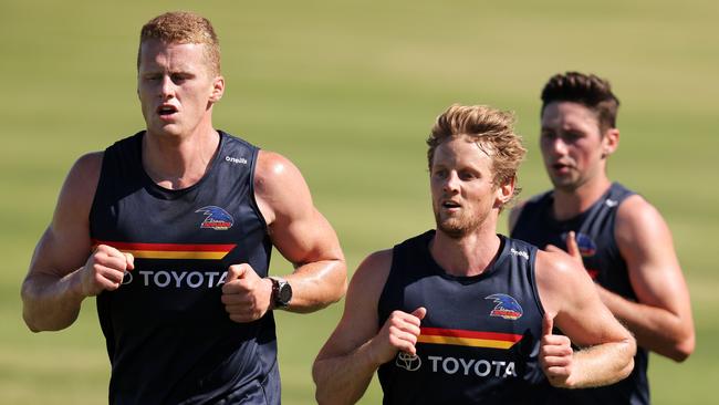 Reilly O’Brien, Rory Sloane and Chayce Jones hit the track. Picture: Daniel Kalisz/Getty Images