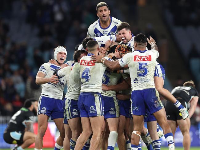 SYDNEY, AUSTRALIA - JUNE 28:  Matt Burton of the Bulldogs celebrates with team mates after kicking a golden point field goal in extra time to win the round 17 NRL match between Canterbury Bulldogs and Cronulla Sharks at Accor Stadium on June 28, 2024, in Sydney, Australia. (Photo by Cameron Spencer/Getty Images)