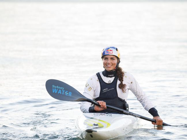 Olympian Jess Fox with her kayak during filming for a TV commercial on the harbour at McMahons Point, to launch her new role as brand ambassador for Sydney Water. 30/07/2023. Pic by Max Mason-Hubers