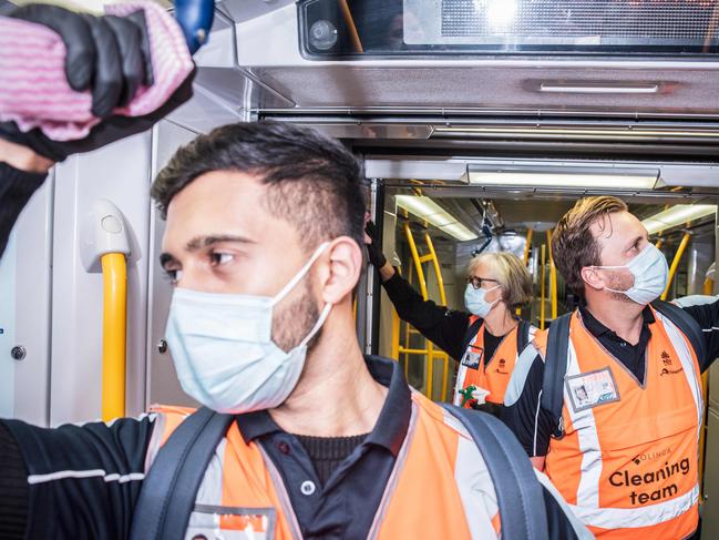 L-R Photo of NSW Transport cleaners, Rahil Nerkar; Judy Navidi and Andrew Kroenert, working on a train wagon. On Friday 18 September 2020.(Sunday Telegraph/Flavio Brancaleone)