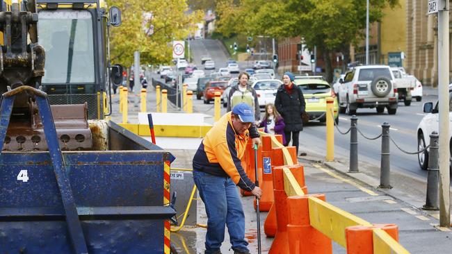 Contractors and council workers scoop up debris from the storm. Picture: MATT THOMPSON