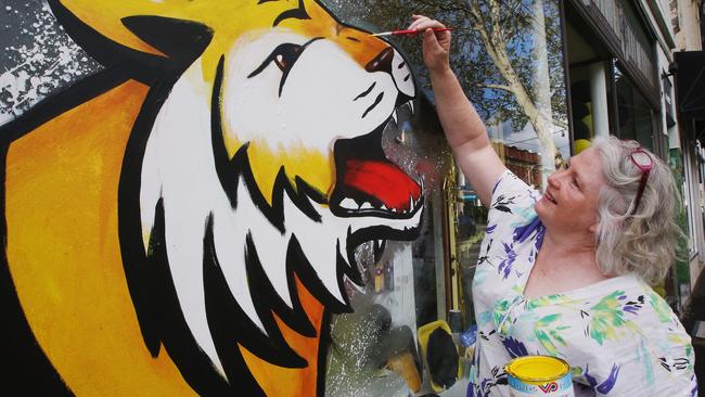 Artist Jacqui McKinnon paints a mural at Richmond’s Burnt Butter Cakes bakery. Picture: Michael Dodge/Getty Images