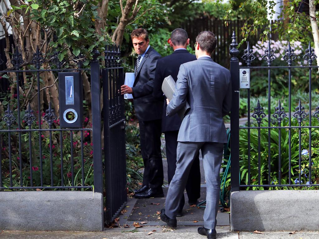 Men in suits arrive at the home of Rosemary Rogers in Williamstown. 