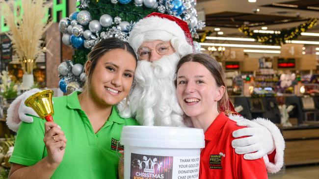 Father Christmas helps kick off The Advertiser Foundation Kids Christmas Appeal with customer service assistants Katie Abbott and Abbie Mitchell at Brighton Foodland. Picture: Brenton Edwards