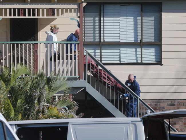 Police remove the body of Tina Kontozis from her home today.