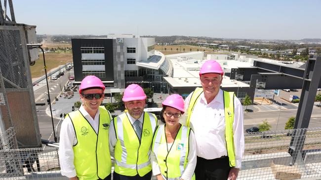 Greenfields Development Company director Mark Perich, Camden Council general manager Ron Moore, Camden Mayor Therese Fideli and Tony Perich on top of the Camden area’s new tallest building. Picture: Robert Pozo