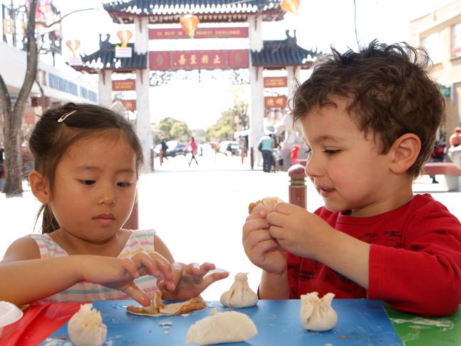 Maiya Do, 3, and Christian De Nuntiis, 3, making dumplings for Moon Festival in Cabramatta.