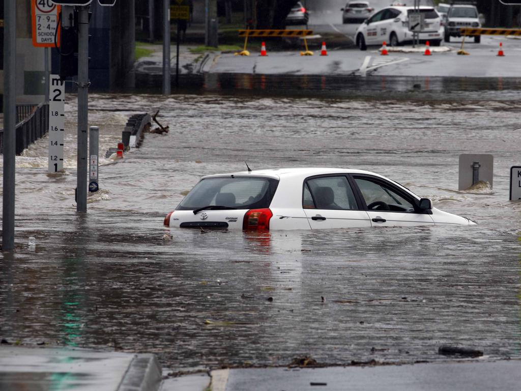 A car is stuck in flood waters in Toombul after heavy rain fell overnight in Brisbane. Picture: Tertius Pickard