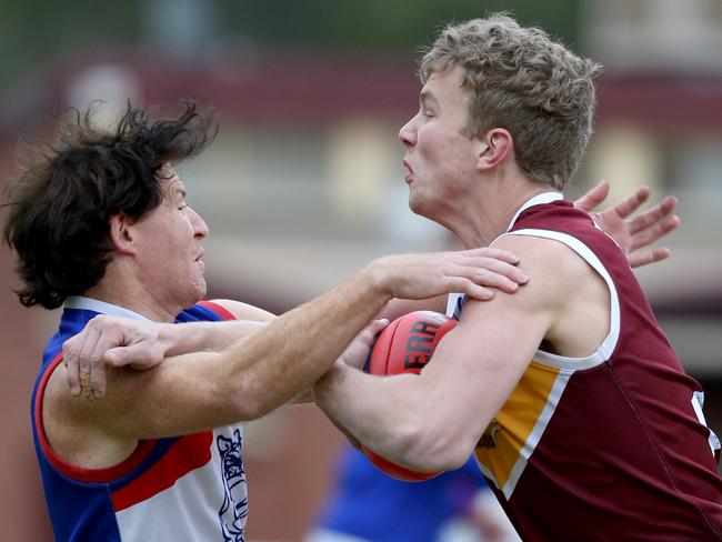 Tom Keys brushes off a tackle from North Heidelberg’s Shane Harvey. Picture: Mark Wilson