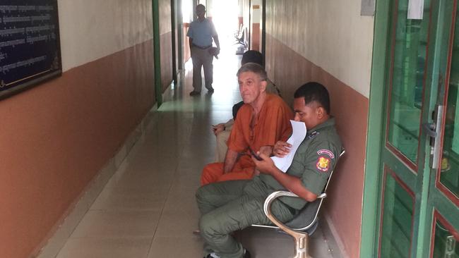 Garry Mulroy (in orange) is seen before a court hearing in Phnom Penh, Cambodia, Friday, March 6, 2020. Mulroy is accused of molesting boys between ages of 11 and 14. (AAP Image/Craig Alexander) NO ARCHIVING