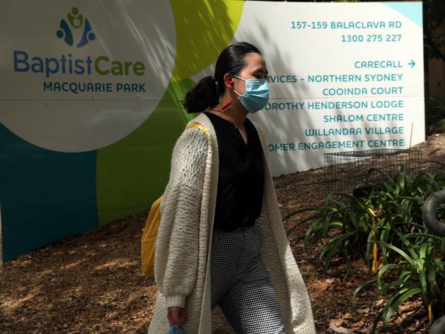 08/03/2020. A woman walks past the Dorothy Henderson Lodge in Marsfield where an elderly resident died of Corona virus last night. Jane Dempster/The Australian.