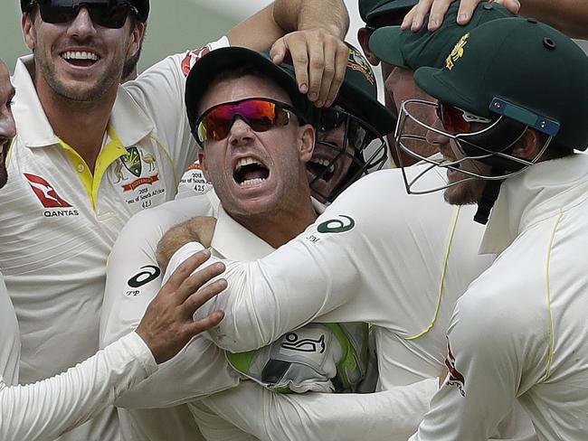 Australia's bowler Nathan Lyon, left, and teammates celebrate after running out South Africa's batsman AB de Villiers, far right, for a duck on day four of the first cricket test match between South Africa and Australia at Kingsmead stadium in Durban, South Africa, Sunday, March 4, 2018. (AP Photo/Themba Hadebe)