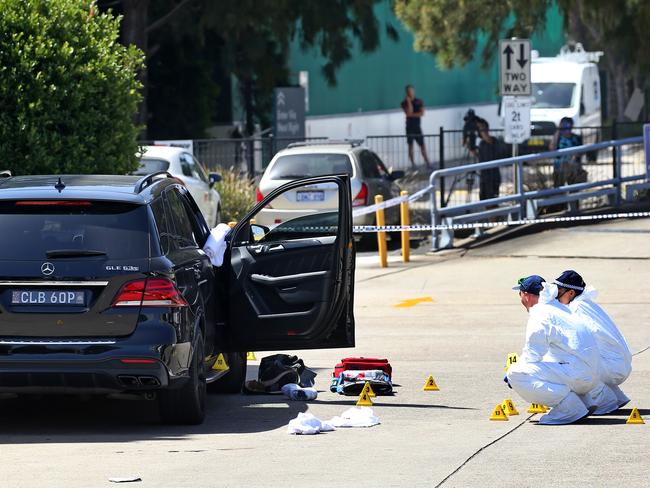 Hawi’s car, in which he was killed, is examined by police. Picture: Toby Zerna