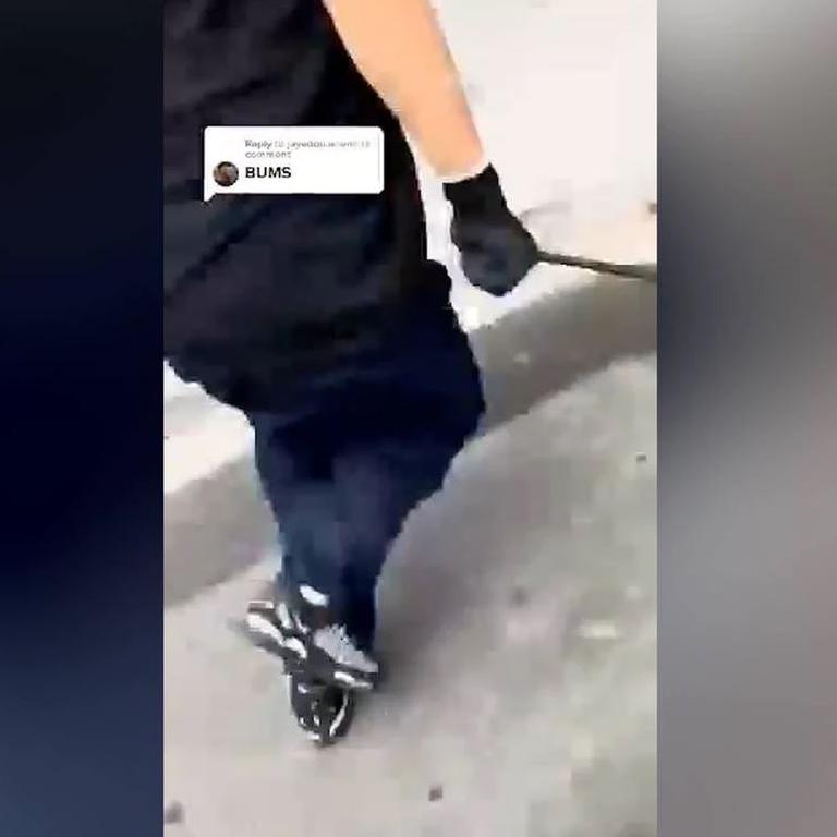 A person appears to hold a weapon in a gloved hand as they enter a store in one video. Picture: TikTok.