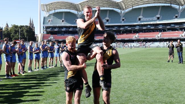 Andrew Bradley is chaired off following his 200th game for Glenelg – last season’s SANFL elimination final against Sturt. Picture: SANFL/David Mariuz