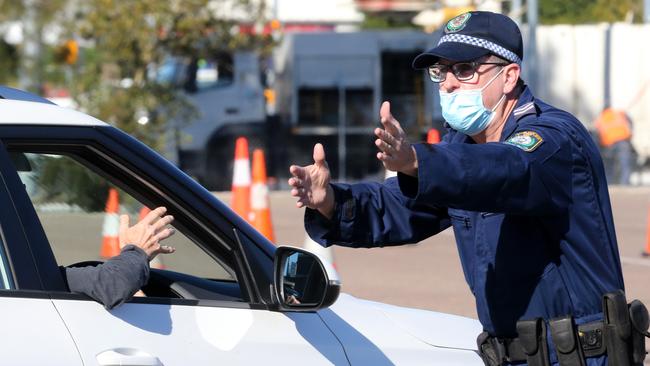 A police officer is abused by an impatient driver at the new pop-up clinic at McDonald Jones Stadium. Picture: Peter Lorimer.