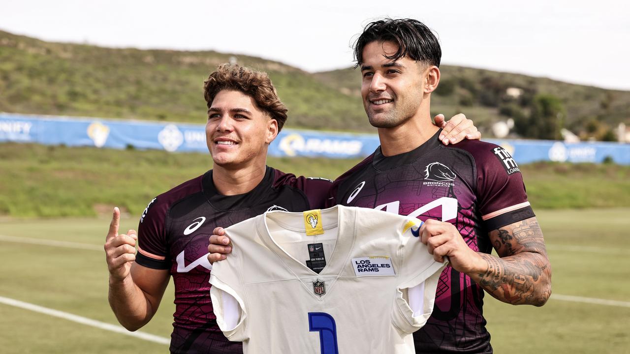 Reece Walsh and Jesse Arthars pose for a photo with a Los Angeles Rams jersey. Photo by Michael Owens/Getty Images.