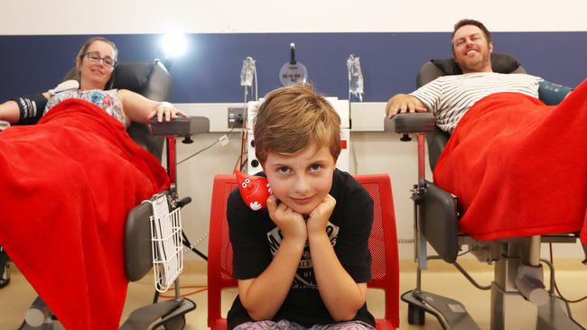 Eight year old Gold Coast boy Kobi McDonald was born with a rare genetic blood disorder with his mum Rebecca and Dad Nigel at the Red Cross Blood Centre Robina. Photograph: Jason O'Brien