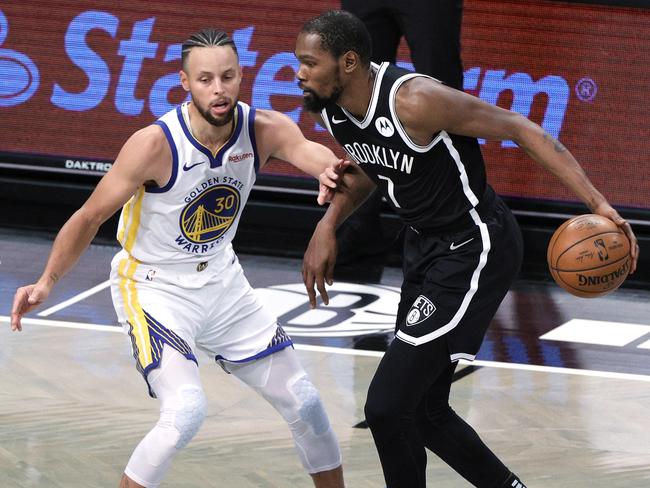 Kevin Durant dribbles against Stephen Curry after leaving the Warriors for the Nets. Picture: Sarah Stier/Getty Images