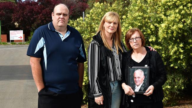 Oakden whistleblowers — Stewart Johnston with Alma Krecu and her mum Rina Serpo (holding photo frame of her husband Ermanno “Eddie” Serpo, who was a resident at the Oakden mental health facility) outside the facility. Picture: Keryn Stevens