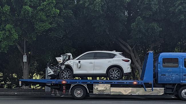 A tow truck removes a vehicle which crashed on the Gold Coast Highway in Southport after the driver suffered a medical incident. Picture: Keith Woods.