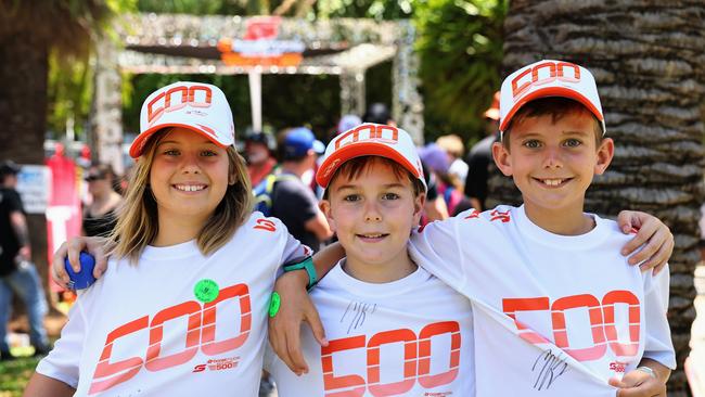 Stevie Rose, 9, Wade Peall, 11, and Jack Rose, 11, bought some GC500 merchandise and got their favourite driver, Brodie Kostecki, to sign their shirts on day one of the Gold Coast 500 Supercars, held at the Surfers Paradise street circuit. Picture: Brendan Radke