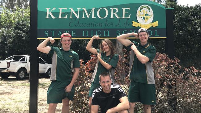 Kenmore State High School chaplain Justin Prestidge (front) with students Thomas Saxby, Phaedra Keefe and Douglas Dover, wearing the sports uniform.