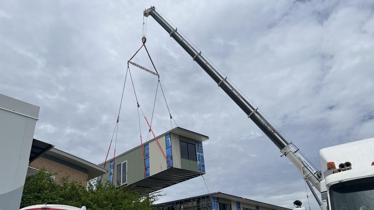 A crane drops in the final building module into the new ward, set for full operations by 2025.