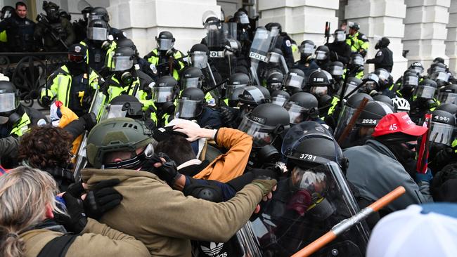 Riot police push back a crowd of supporters of Donald Trump after they stormed the Capitol building on January 6. Picture: AFP