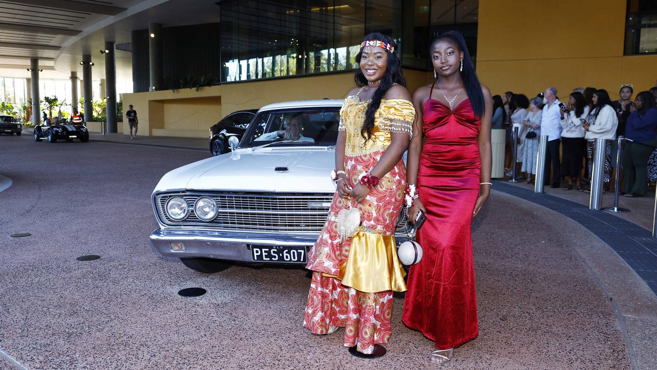 Grace Kazadi and Ivy Mwayuma arrive at the Peace Lutheran College formal evening at the Cairns Convention Centre. Picture: Brendan Radke