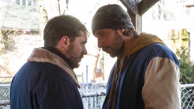 Actor Matthias Schoenaerts stands over Tom Hardy in a scene from The Drop. Picture: Supplies