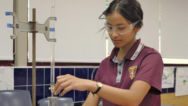 Lauren Singh demonstrates an acid-base titration in her school science laboratory.