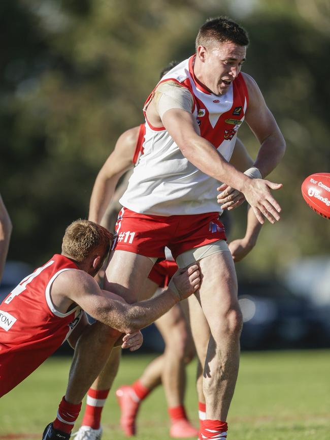 Justin Farrelly (Karingal) breaks a tackle.                         <a class="capi-image" capiId="bcbb2ba3f25915ed65769dd1f0f9d51e"></a>