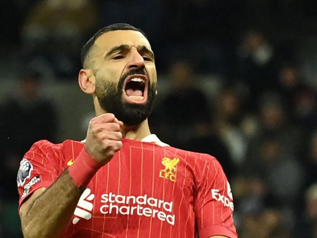 Liverpool's Egyptian striker #11 Mohamed Salah celebrates after scoring their fourth goal during the English Premier League football match between Tottenham Hotspur and Liverpool at the Tottenham Hotspur Stadium in London, on December 22, 2024. (Photo by Glyn KIRK / AFP) / RESTRICTED TO EDITORIAL USE. No use with unauthorized audio, video, data, fixture lists, club/league logos or 'live' services. Online in-match use limited to 120 images. An additional 40 images may be used in extra time. No video emulation. Social media in-match use limited to 120 images. An additional 40 images may be used in extra time. No use in betting publications, games or single club/league/player publications. /