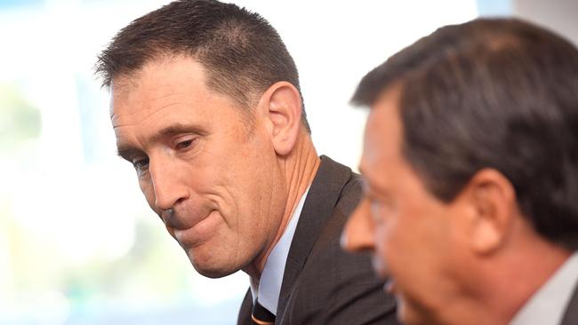 Cricket Australia CEO James Sutherland (L) listens to Cricket Australia chairman David Peever (R) during a press conference in Melbourne on June 6, 2018, where Sutherland announced he will stand down in the wake of the ball-tampering scandal that rattled the game. Sutherland, who has been chief executive for 17 of his 20 years with Cricket Australia, has given 12 months' notice and will continue in his role until a suitable replacement is found. / AFP PHOTO / William WEST