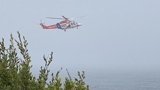 A helicopter scours waters off Kilcunda for a missing fisherman on Sunday. Picture: Twitter/@davmoro