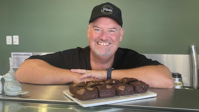 Evan Munroe with a tray of fresh brownies set for the display cabinet.