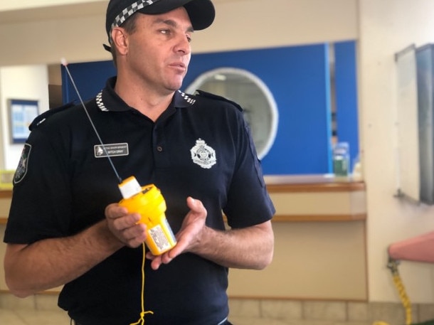 Gold Coast water police acting senior sergeant Mitch Gray with an Emergency Position Indicating Radio Beacon. Picture: Annie Perets