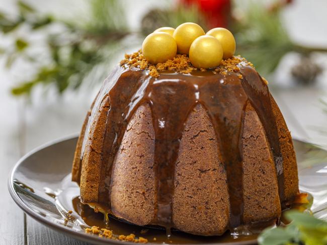 A Christmas pudding served with caramel sauce.