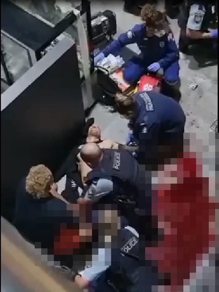 Emergency services personnel work on Zahed after he and his brother Omar were shot multiple times at the Bodyfit gym in Auburn.