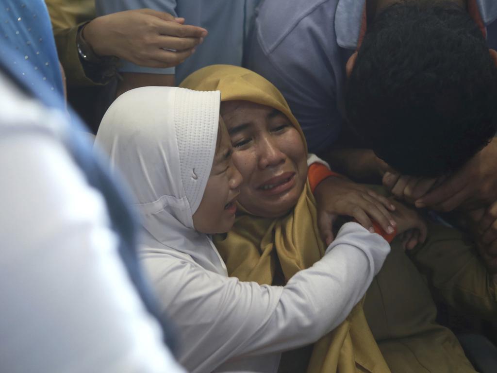 Devastated family members comfort each other as they wait for news on a Lion Air plane that crashed off Java Island at Depati Amir Airport in Pangkal Pinang. Picture: AP