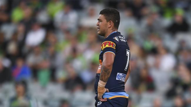 NRL matches will go ahead, but players will take to the field in empty stadiums. Pictured is Ash Taylor of the Titans. Picture: AAP Image/Lukas Coch